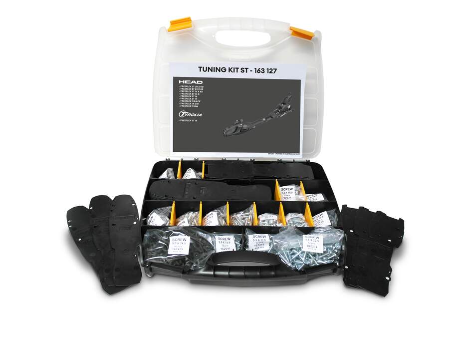 Das Head Tuning KIT ST von Head wird in einem Kunststoffkoffer mit beschrifteten Fächern geliefert, die Werkzeuge, Schrauben, schwarze Platten und eine Anleitung zum Tuning von Skiern oder Snowboards enthalten. Der geöffnete Deckel zeigt den Inhalt übersichtlich an.
