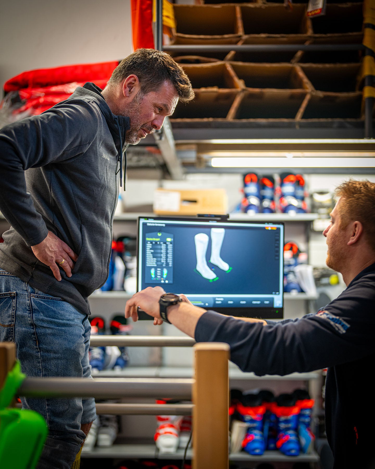 Franz Simmerl fuehrt eine digitale Fussvermessung zur individuellen Anpassung von Skischuhen durch – moderner Bootfitting-Service im Sportgeschaeft mit 3D-Scanner und Beratung.